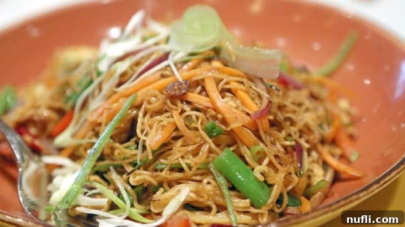 noodle dish in a orange bowl 