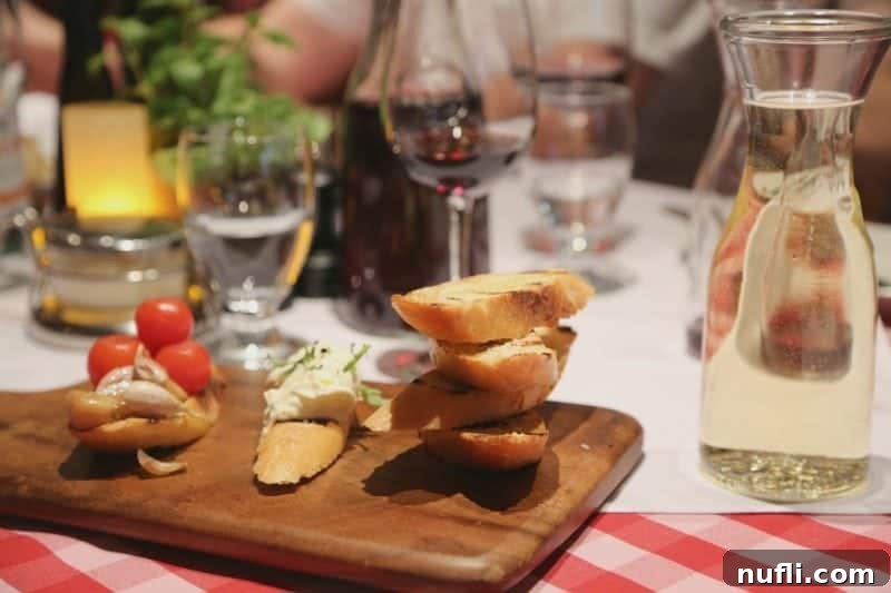 Freshly baked bread on a rustic cutting board, artfully placed next to a carafe of fine wine, creating an inviting culinary scene.
