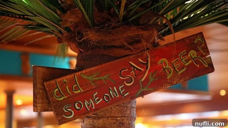 A humorous sign prominently asking 'Did someone say beer?', perfectly placed to entice guests towards the pub area.