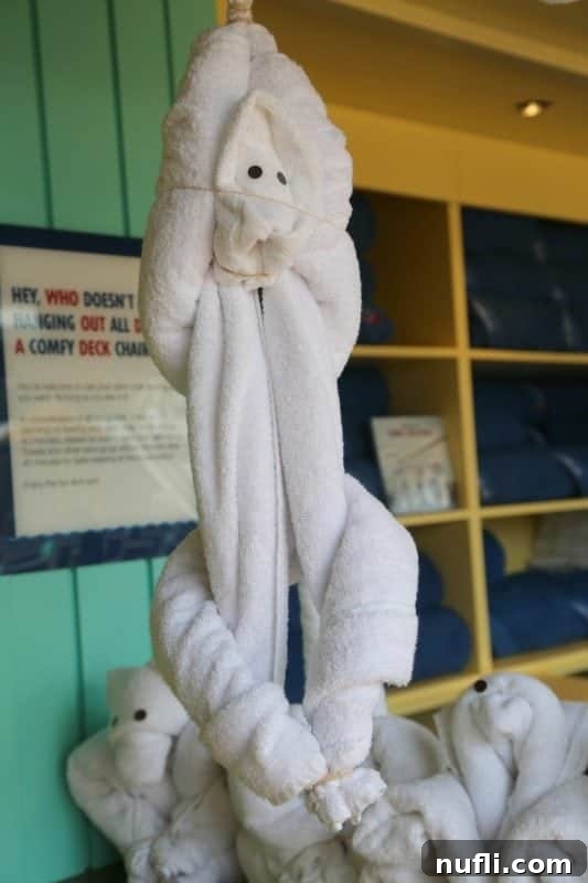 An adorable towel animal monkey, creatively crafted and hanging playfully near other charming towel animals.
