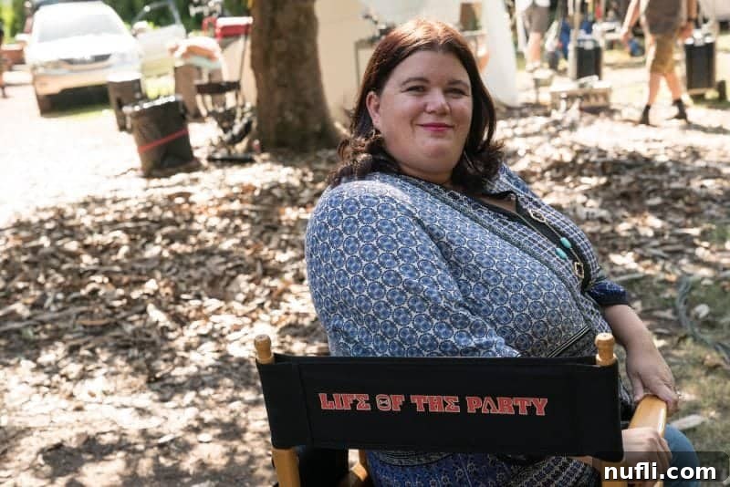 Tammilee sitting comfortably on a branded Life of the Party chair on the movie set, reflecting a personalized experience.