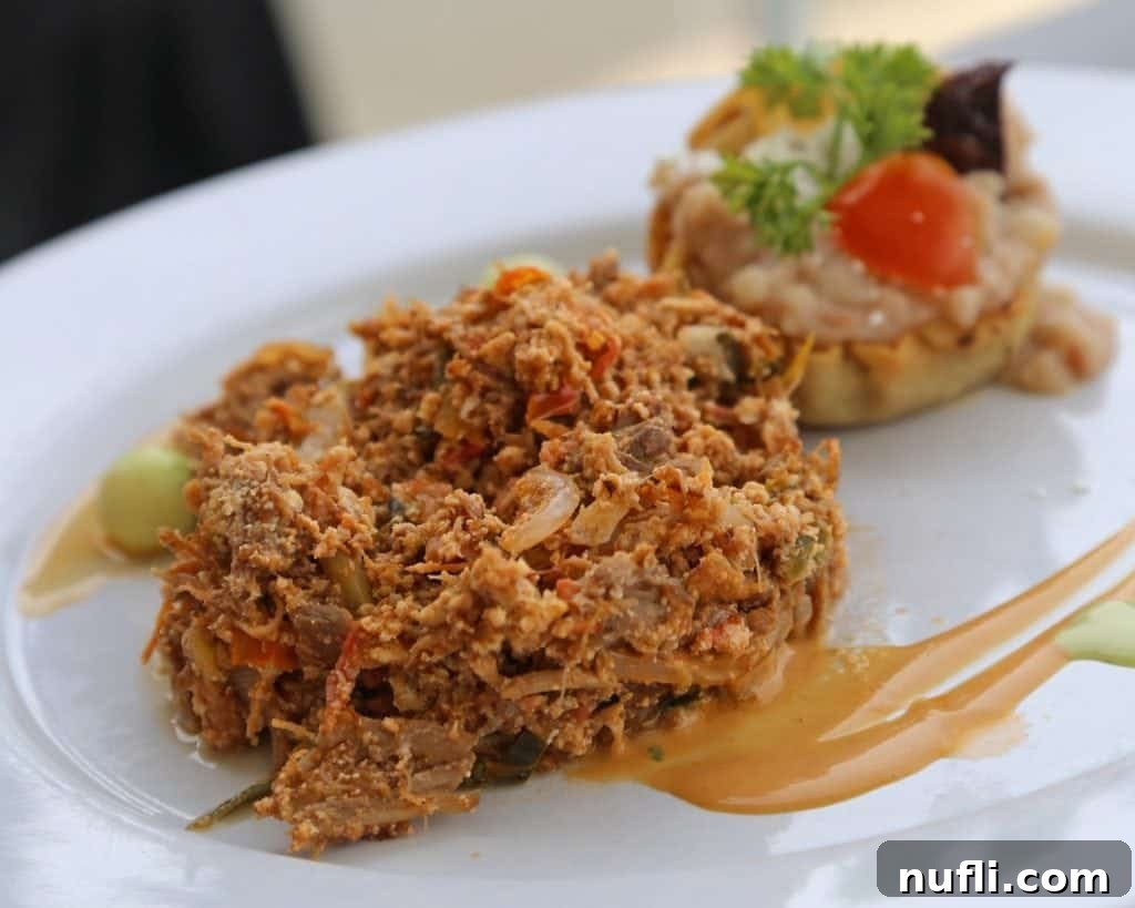 breakfast on a white plate with sauce