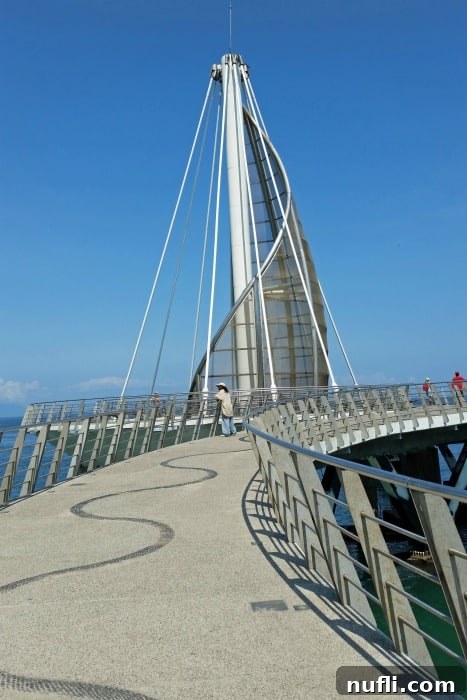 Walking up a concrete pier with a sculpture sail