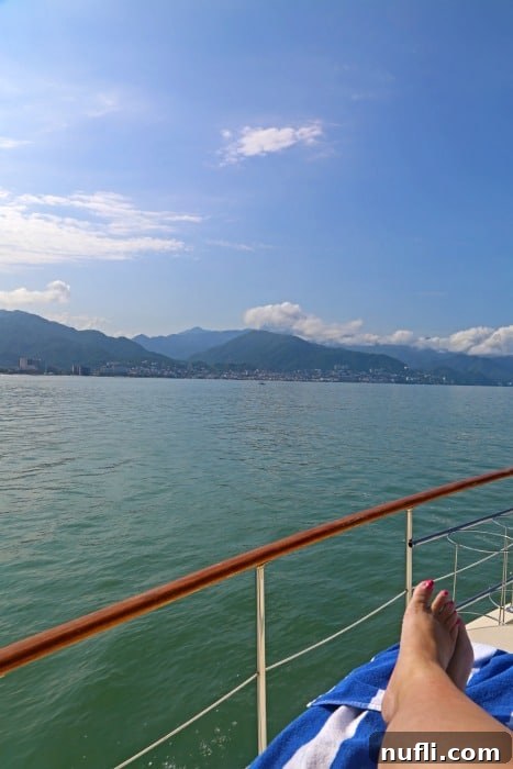 legs on a boat looking out over the Bay of Banderas