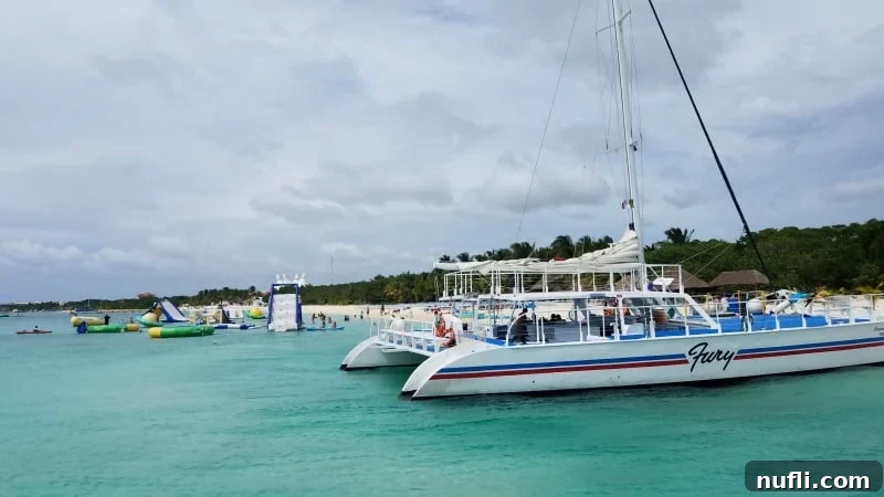 A catamaran in tropical waters with play are nearby