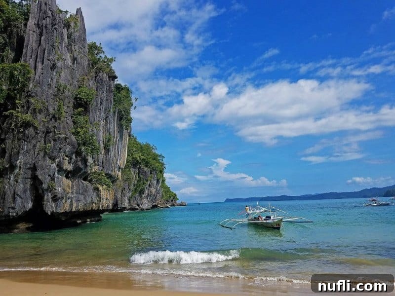 Gorgeous water with boat and tall cliffs to the side in Puerto Princesa 