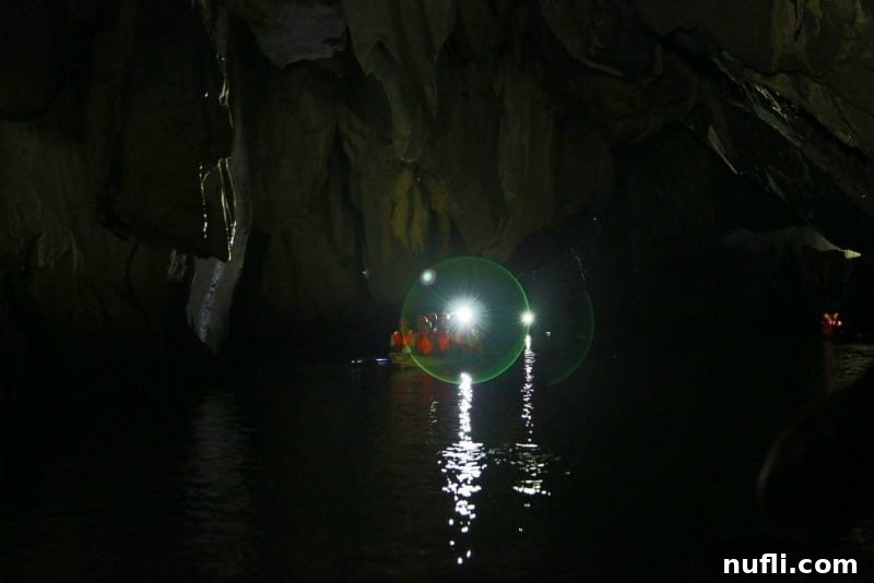 light from a canoe across the water in a cave