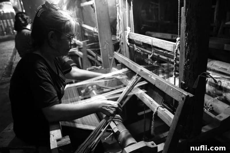 Discover Puerto Princesa: Your Palawan Adventure Guide 5 Close-up of a large weaving machine with intricate threads, operated by women