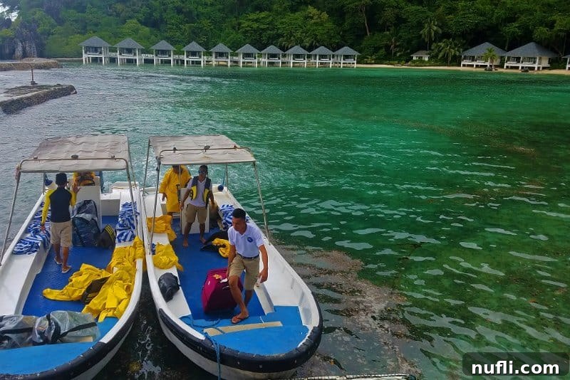 Two boats unloading suitcases with yellow rainjackets in the boat