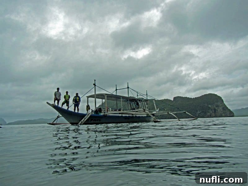 boat with people standing on it on a grey day 