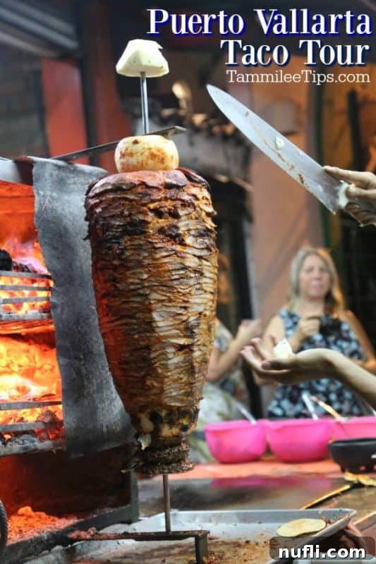 Close-up of a hand holding a knife, expertly slicing succulent meat from a vertical grill, ready for delicious tacos on a Puerto Vallarta food tour.