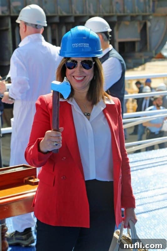 Carnival President Christine Duffy, holding a ceremonial axe, preparing to participate in the keel laying tradition.