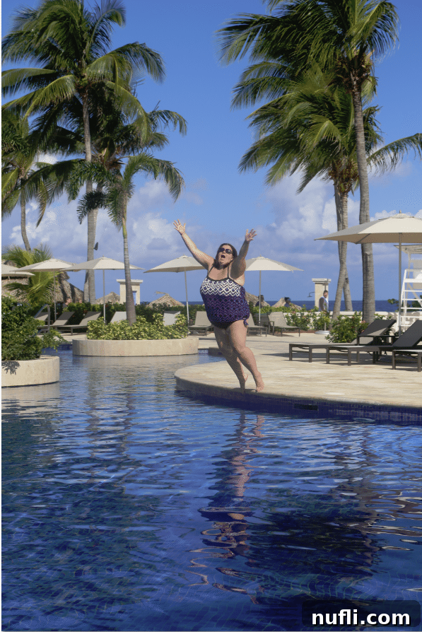 Joyful leap into a Jamaican pool while wearing a swimsuit, an empowering travel memory