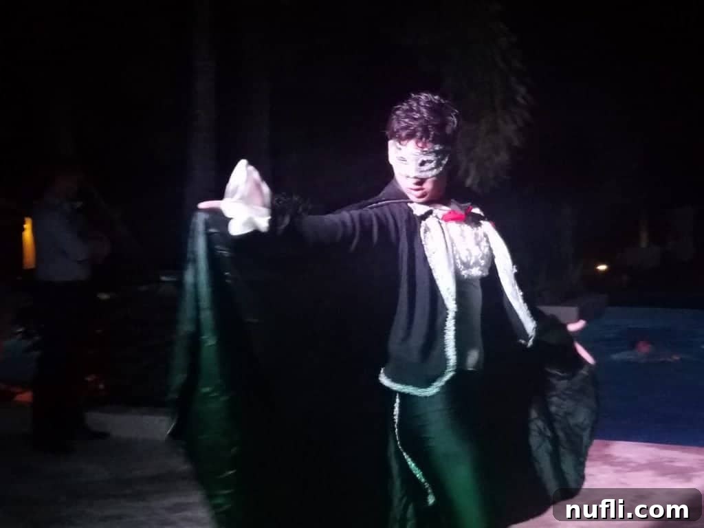 Phantom of the Opera performer in a dramatic pose by the pool at a Jamaican resort