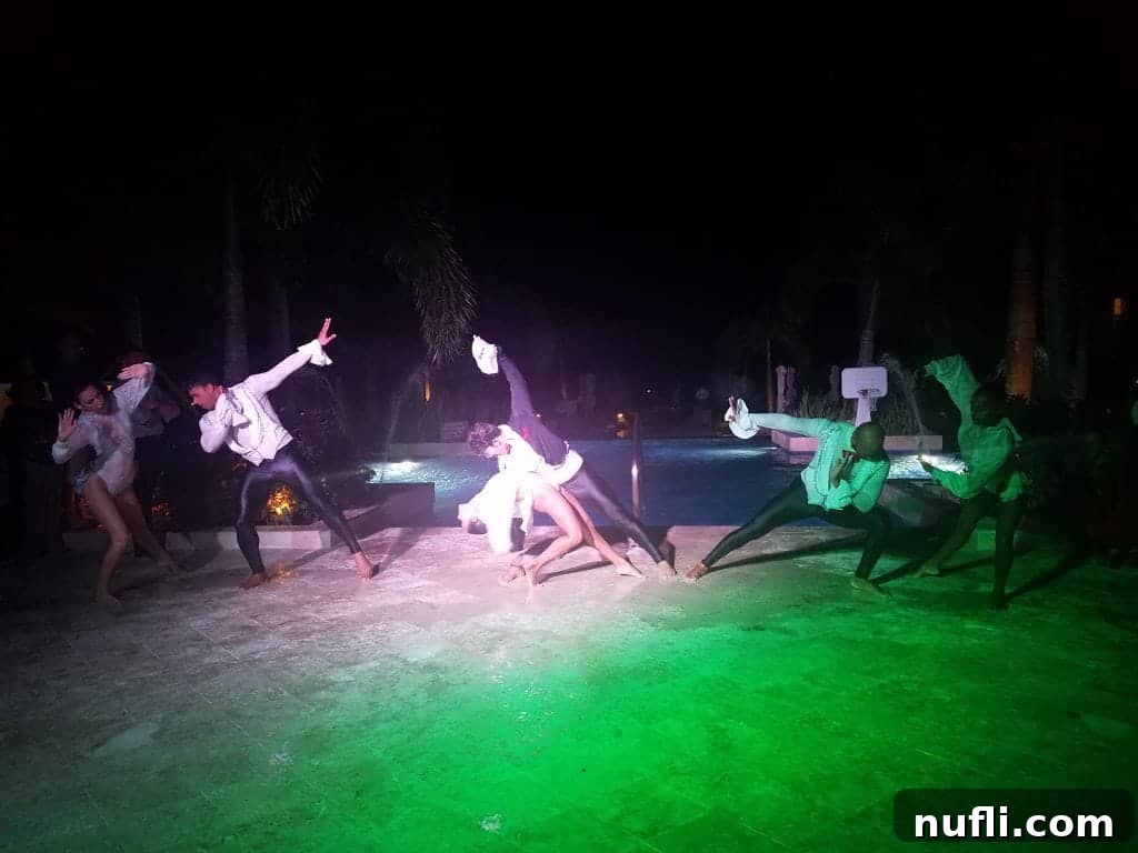 Phantom of the Opera performers near a brightly lit swimming pool during an evening show in Jamaica