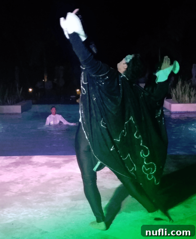Synchronized swimming performers in and near a pool, showcasing intricate water routines in Jamaica