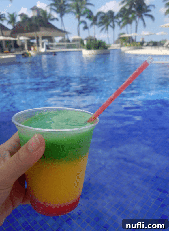 Colorful Bob Marley cocktail by a swimming pool in Jamaica, a must-try drink