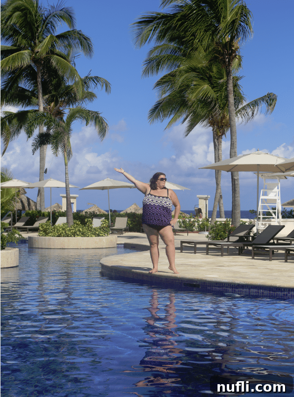 Woman confidently posing in a swimsuit by the pool in Jamaica, embracing body positivity