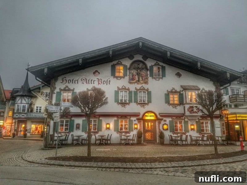 Hotel Alte Boft, a building adorned with intricate paintings on its facade.