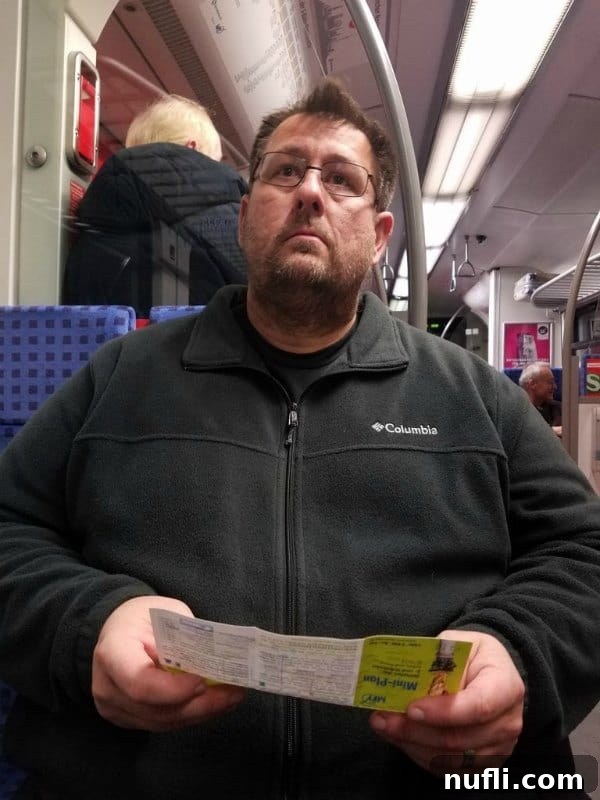 John riding the train, capturing a moment of public transport travel.