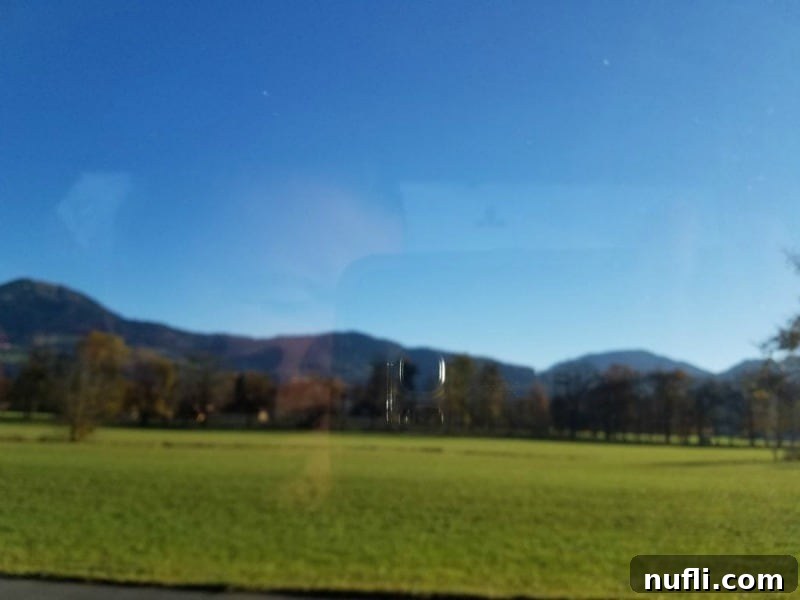 A blurred view of a picturesque field from a moving bus window, capturing the speed of travel.
