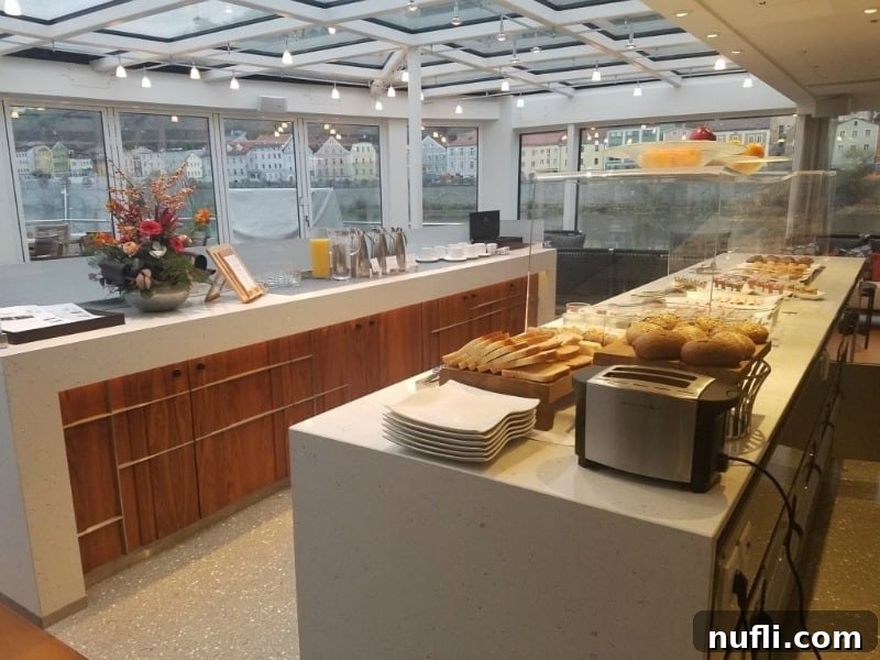 The Aquavit Terrace with a lavish breakfast spread laid out on two counters, overlooking a scenic view.