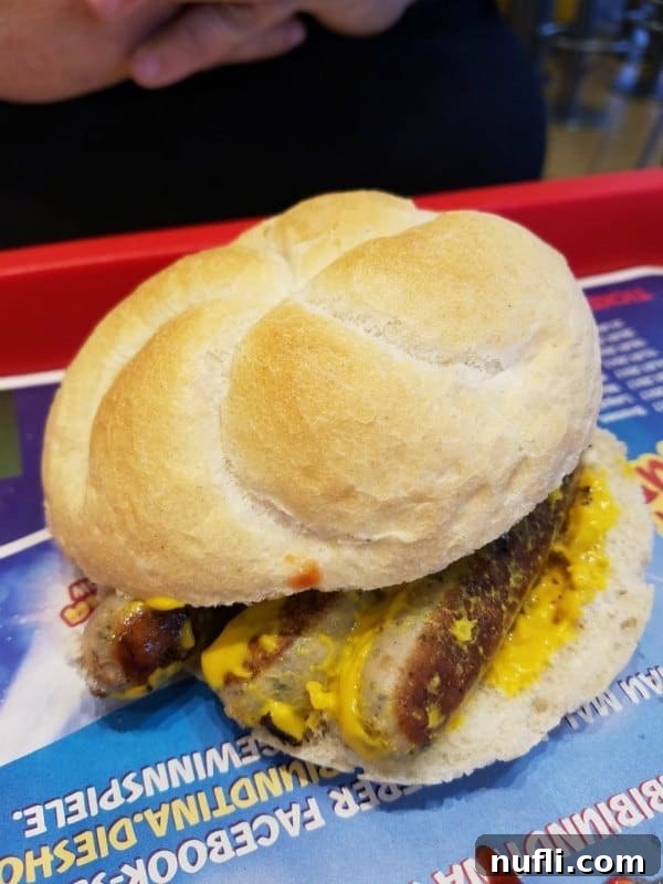 A German sausage sandwich with mustard on a McDonald's tray, a unique European menu item.
