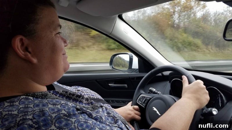 Germany: Where I Found What My Life Was Missing 2 Tammilee driving a jaguar on the Autobahn in Germany, showcasing the thrill of high-speed driving