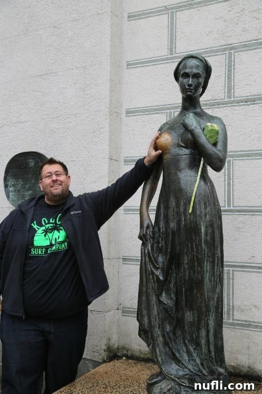 John reaching out to touch the Juliet statue in Munich