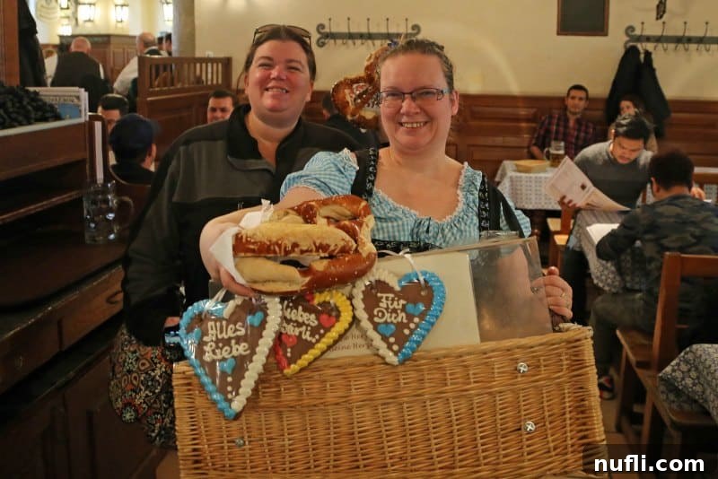 Tammilee holding a giant pretzel at Hofbräuhaus Munich with a pretzel seller