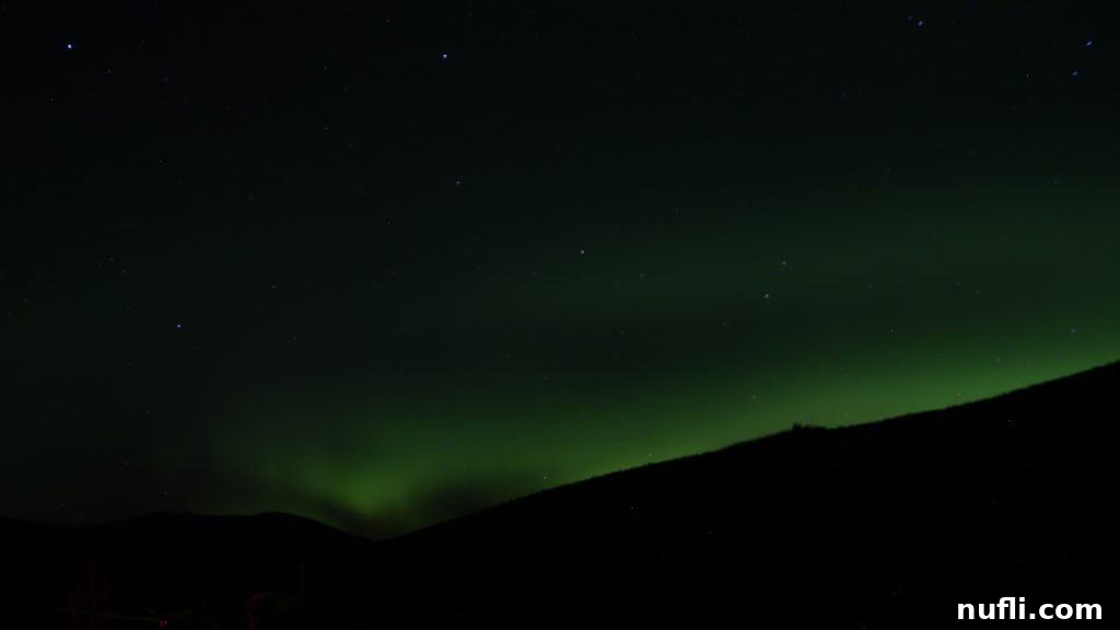Swirling green Aurora Borealis lights up the Alaskan winter night