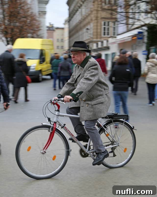Man on a bike riding past people