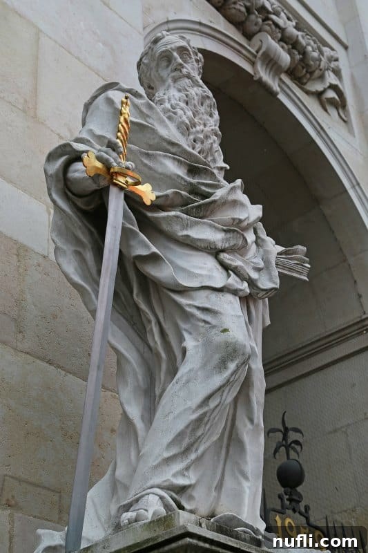 sculpture holding a sword with a golden handle