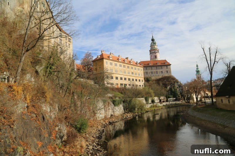 Scenic view down the Vltava River towards Cesky Krumlov Castle, adorned with fall foliage
