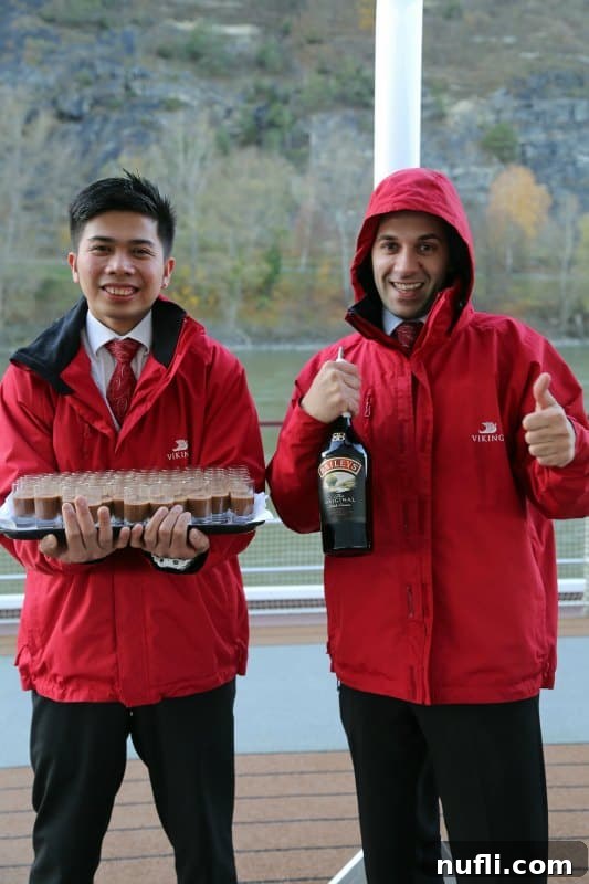 Cruising Austria's Wachau Valley with Viking 3 Viking River Cruise employees in red jackets serving hot chocolate and Bailey's to guests on the deck