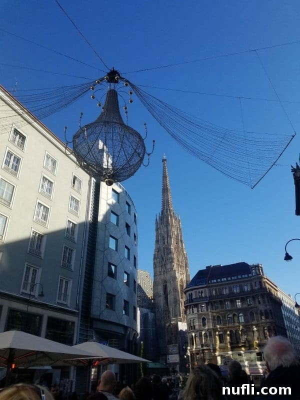 What Austria Taught Me I Needed 5 Enchanting holiday lights illuminate a historic street in Vienna, showcasing a majestic church and classical buildings