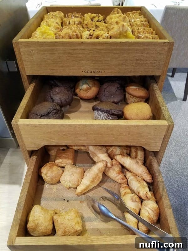 Freshly baked muffins and danishes displayed in wooden baskets on the Viking Vili