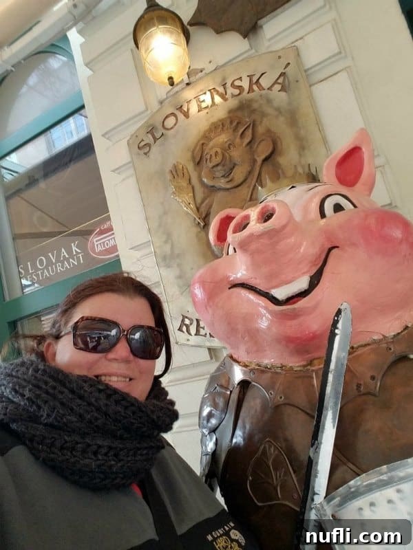 Tammilee standing next to a pig in knight outfit 