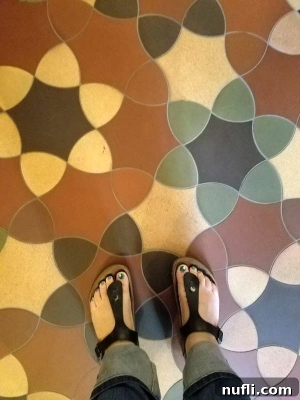 Tammilee wearing birkenstocks on a tile floor 