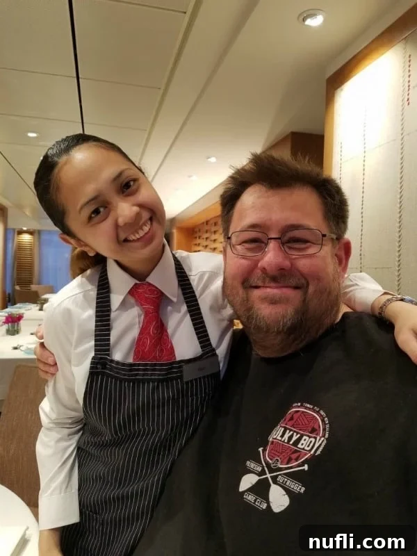 John with Flor, a friendly and energetic waitress on the Viking Vili cruise ship