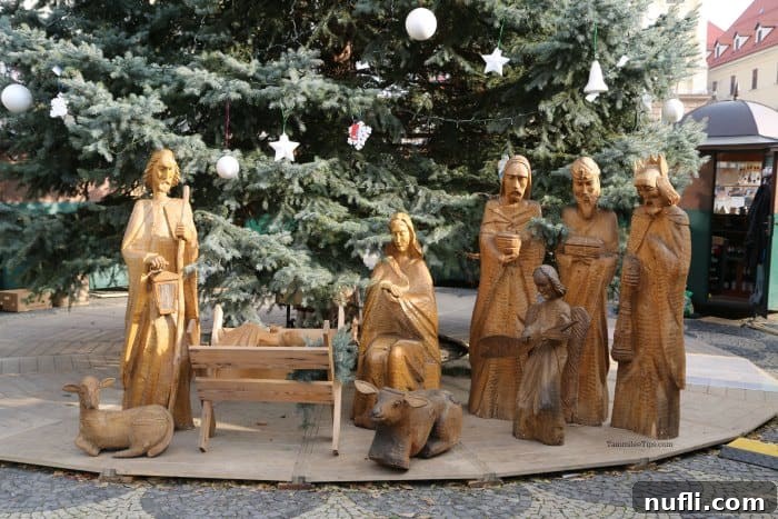 Bratislava Unveiled A Viking River Cruise Walking Experience 6 Charming nativity scene displayed near a decorated Christmas tree, capturing the festive spirit in Bratislava.