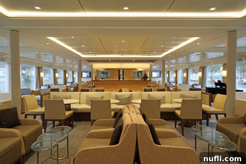 The Viking Vili River Cruise Ship: An Inside Look 10 Observation Lounge on the Viking Vili with lounge chairs and couches in a white bright room