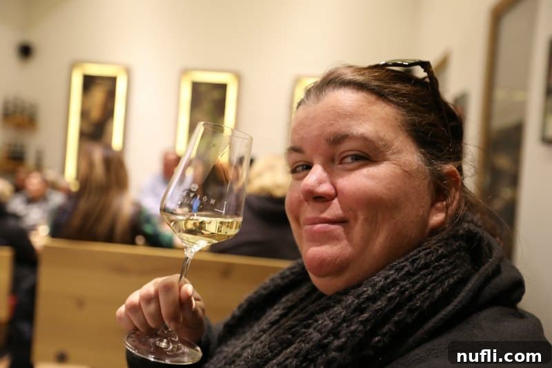 Savor Wachau Valley Wines A Viking River Cruise Excursion 6 Tammilee holding a Morwald wine glass