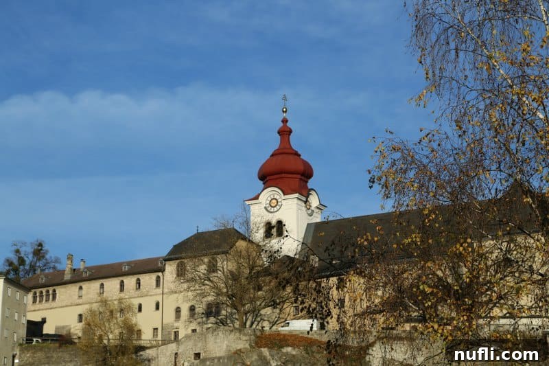 Nonnberg abbey on a hill with red steeple 