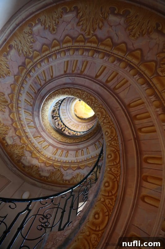 Melk Abbey Austria Baroque Masterpiece 5 A magnificent spiral staircase with elaborate paintings adorning its underside, a true architectural marvel.