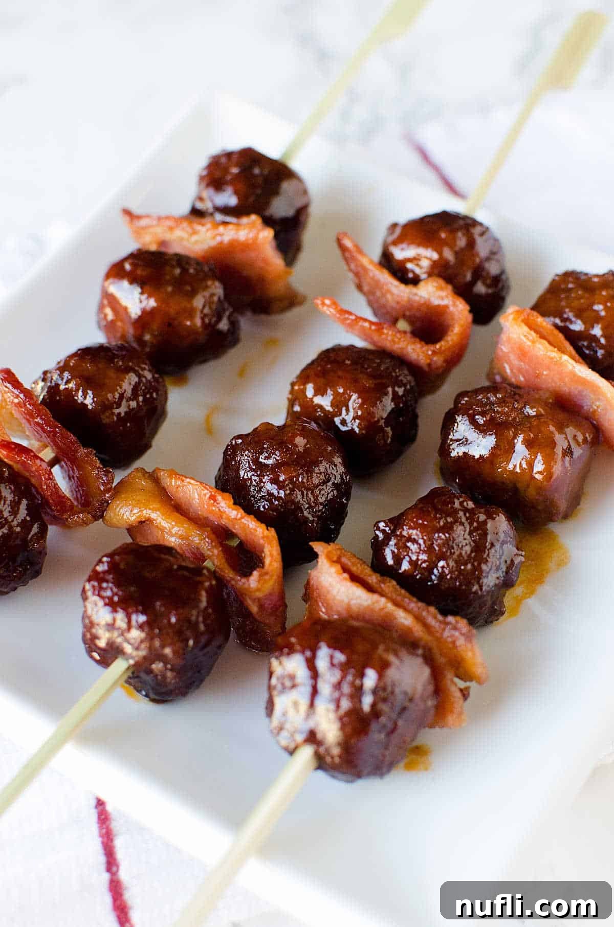 Bacon Bourbon Slow Cooker Meatballs 4 Platter of perfectly cooked Bacon Bourbon Meatballs on wooden skewers, ready to be served at a party.