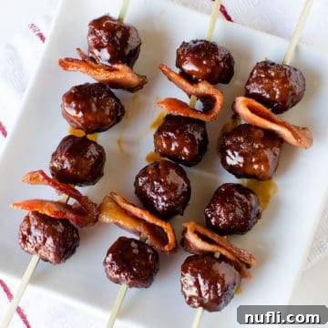 Bacon Bourbon Slow Cooker Meatballs 7 Thumbnail image of Bacon Bourbon Meatballs on skewers, highlighting their delicious texture and sauce.