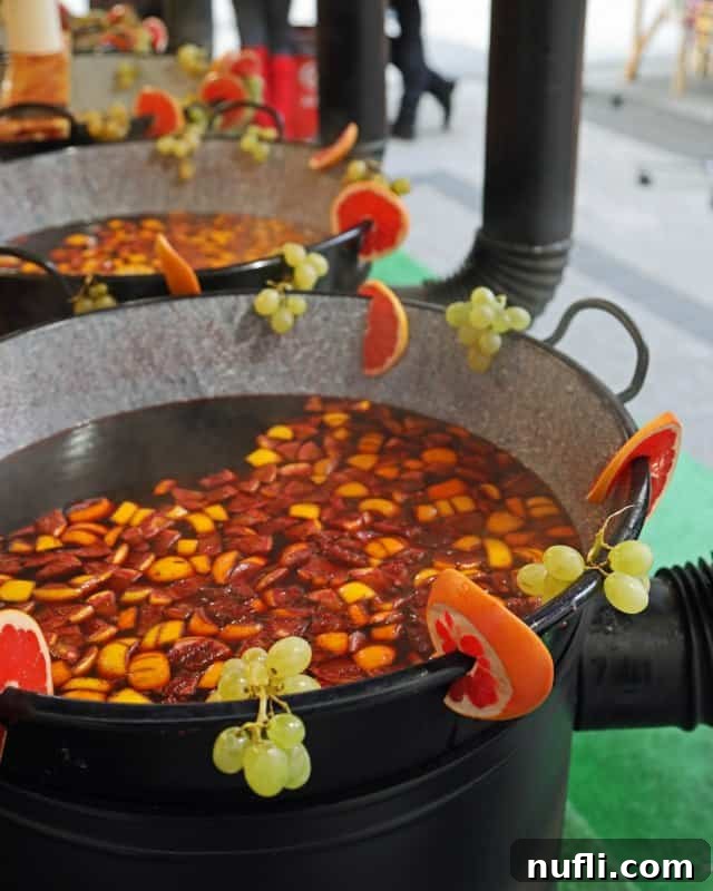 Mulled wine in a barrel with fruit along the edges