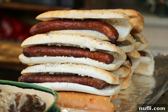 Large hot dogs in buns stacked together