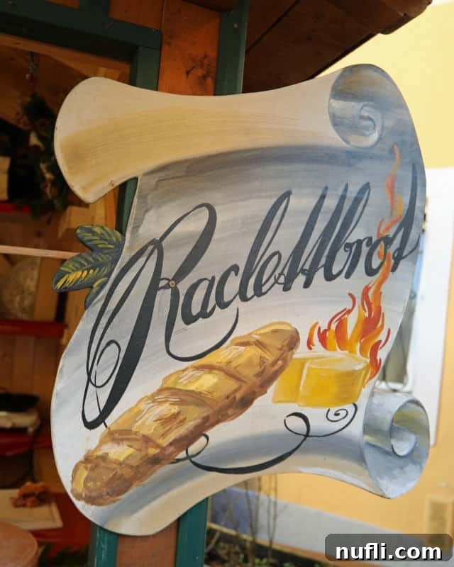 Raclette sign with freshly melted cheese served over bread, a must-try at the market